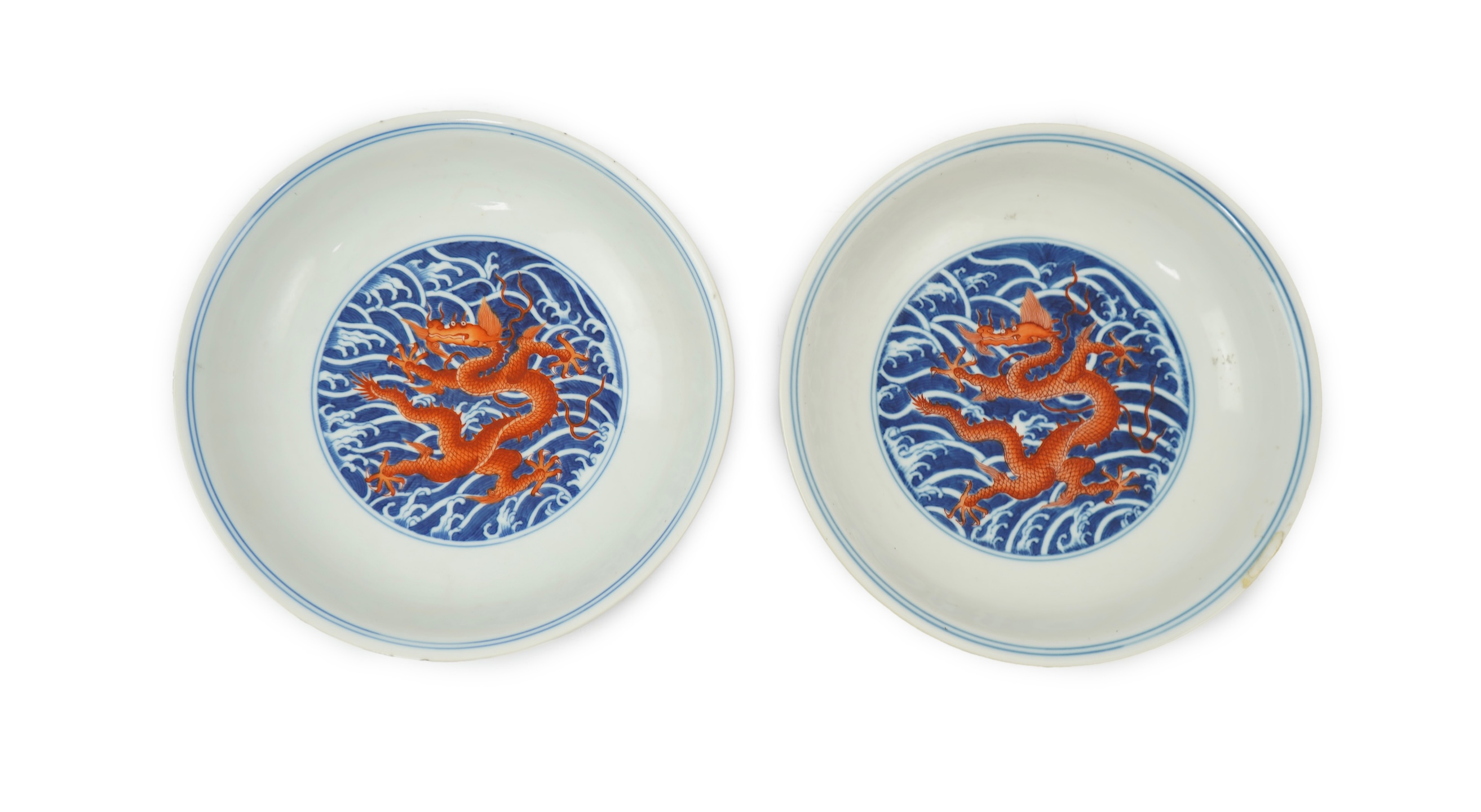 A pair of Chinese iron red and underglaze blue ‘dragon’ dishes, Qianlong seal mark and of the period (1736-95)
